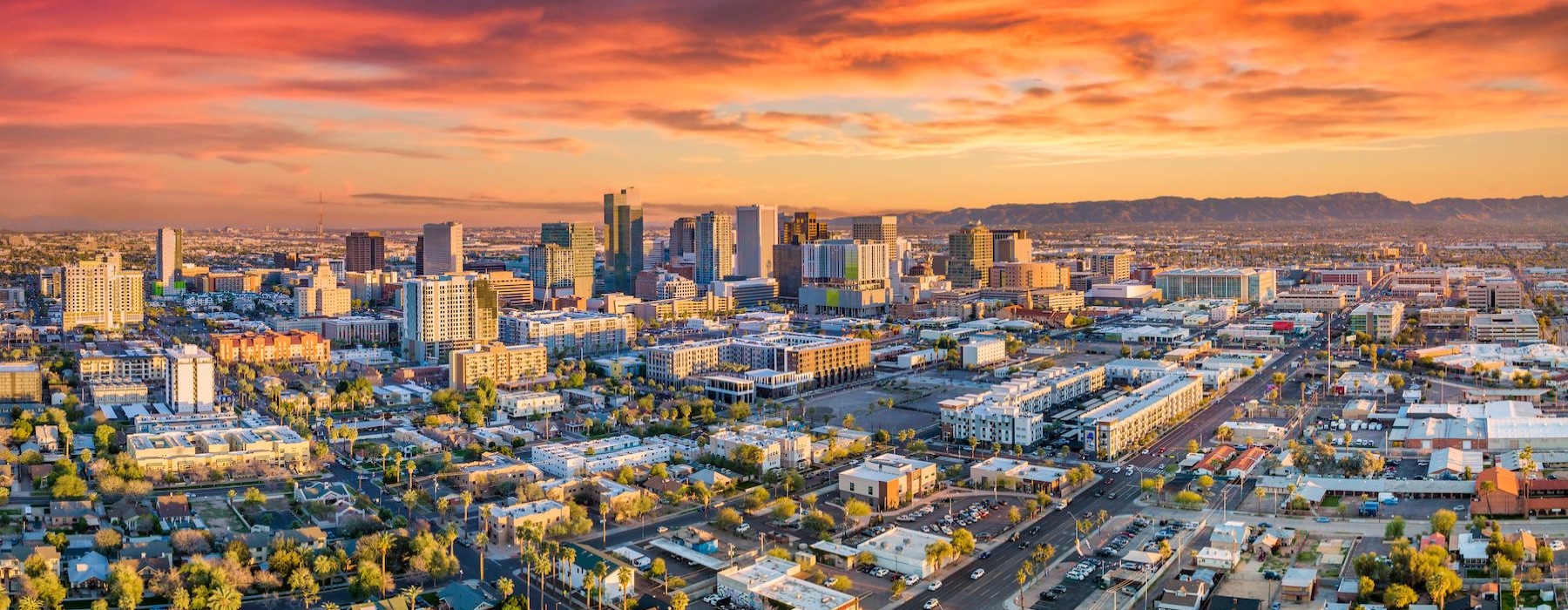 an aerial view of a city with a sunset