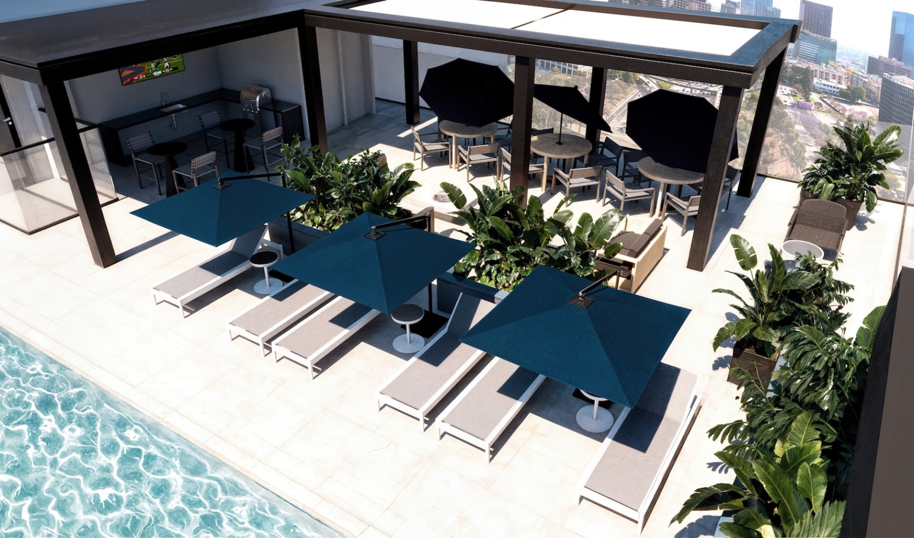 an aerial view of a pool with umbrella-covered lounge chairs 