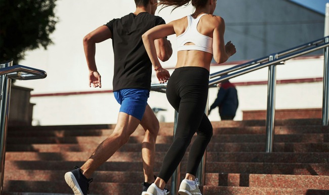a man and woman running up stairs