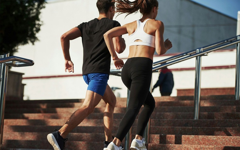 a man and woman running up stairs